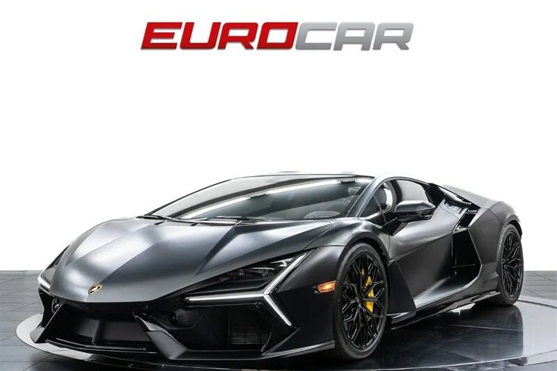 A sleek black 2024 Lamborghini Revuelto with angular design and scissor doors is displayed against a plain white background, with the "EUROCAR" logo above. For sale now, this masterpiece awaits its new owner.