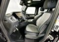 Interior view of the 2025 Electric Mercedes-Benz G-Wagon, featuring black and gray leather seats, a digital dashboard, and a sunroof. For sale now, this luxurious interior offers both style and cutting-edge technology.