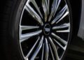 Close-up of a Vistiq car wheel with a shiny, chrome-plated multi-spoke rim and a logo in the center, exemplifying the elegance of a luxury EV.