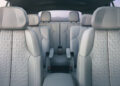 Interior view of the Vistiq, a luxury EV, showcasing three rows of gray leather seats and ample legroom, seen from the front toward the rear.