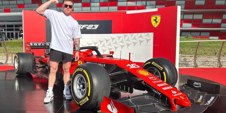 Person posing next to a red Ferrari supercar with iconic branding, in front of a striking red and white building that echoes the prestige of hypercars.