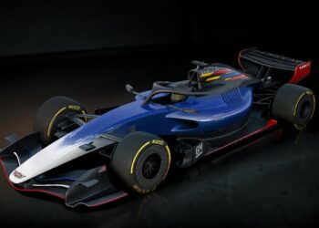 A blue and white Formula 1 race car with yellow tire accents, boasting an aerodynamic design and bold Cadillac sponsorship logos, ready to dominate the F1 grid.