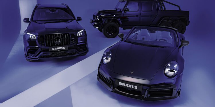 In the Deep Blue Series showroom, three luxury cars—a BRABUS SUV, a BRABUS off-road vehicle, and a convertible sports car—stand majestically in dark hues against a sleek, blue-lit backdrop.