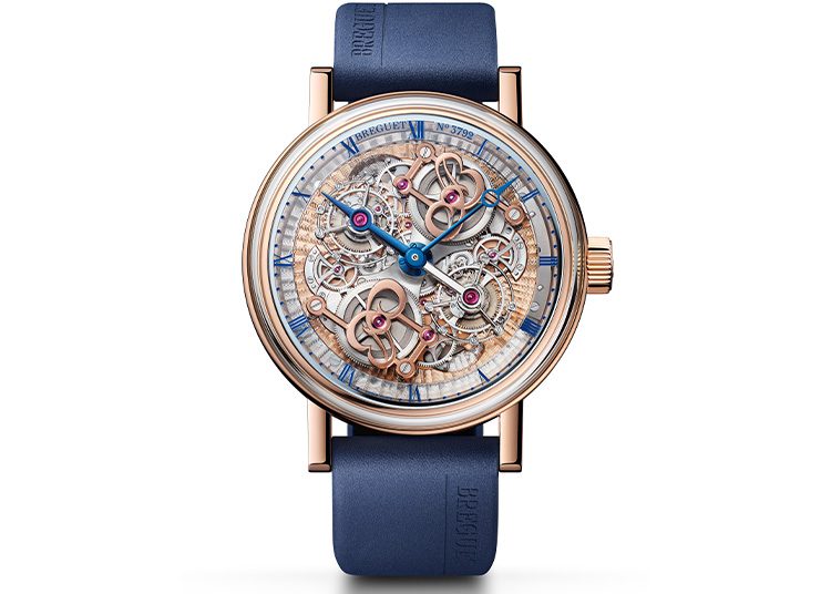 Featured in the 2024 duPont REGISTRY, this luxury watch boasts a blue leather strap and intricate skeleton design with visible gears, complemented by a stunning rose gold case.