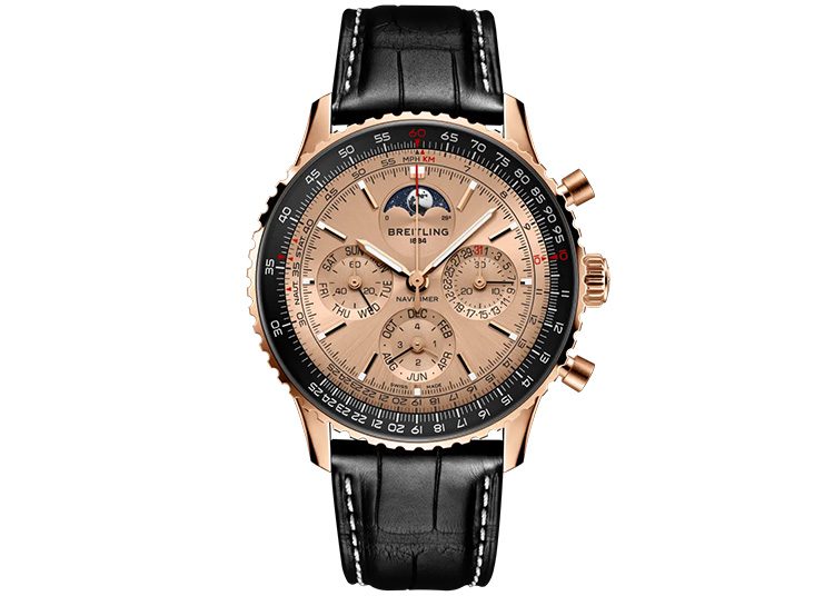 This luxury watch, a gold Breitling chronograph, boasts a black leather strap and showcases multiple dials alongside a moon phase indicator. As featured in duPont REGISTRY's guide to opulent timepieces, it embodies both elegance and precision craftsmanship.