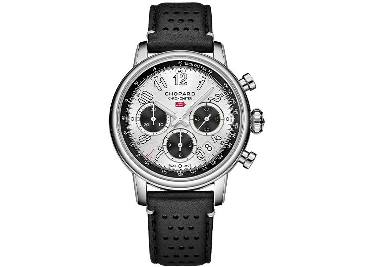 A silver Chopard chronograph from the 2024 Luxury Watch Guide edition features a black leather strap, white dial, black subdials, and silver hour markers. Perfect for those who seek timeless elegance, it's a piece worthy of duPont REGISTRY's discerning eye.