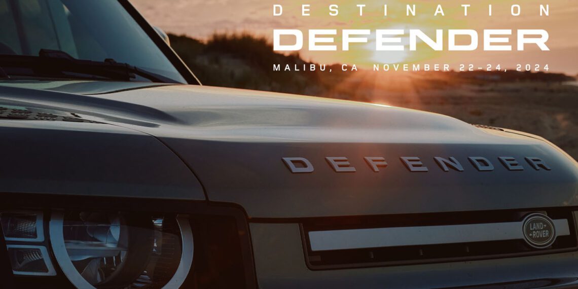 Close-up of a Land Rover Defender with "Destination Defender, Malibu, CA, November 22-24, 2024" text overlay against a stunning Malibu sunset backdrop.