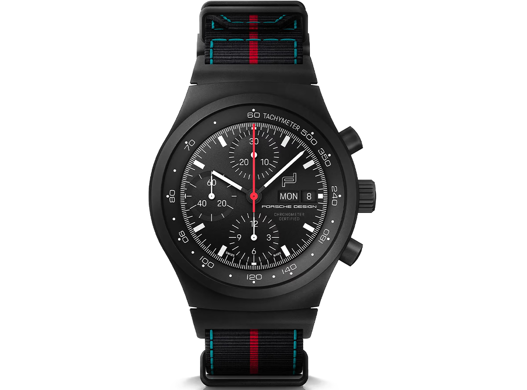 A black Porsche Design chronograph watch with three subdials, day and date display, and a black NATO strap with red and blue stripes—one of the best Porsche watches for style and performance.