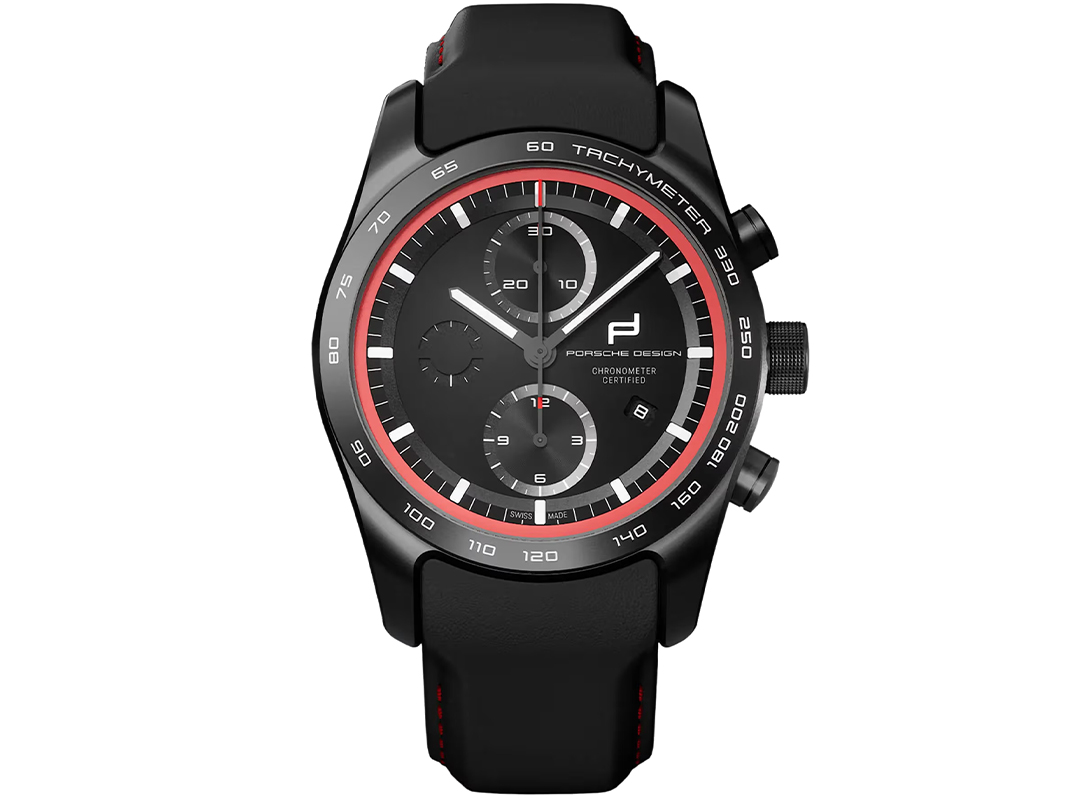 A black Porsche Design chronograph wristwatch with a black dial, red accents, three subdials, tachymeter markings, and a black leather strap—a striking example among the best Porsche watches.