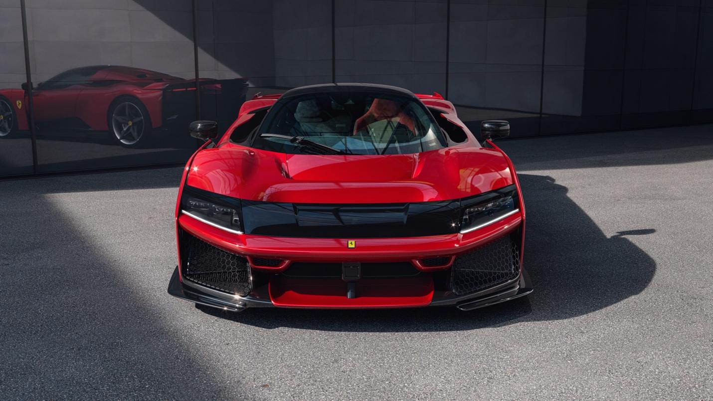 A Ferrari F80 gleams in front of a reflective glass wall, capturing its sleek reflection. Its elegance defies shortsighted criticism, showcasing timeless beauty.