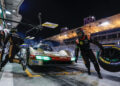 Under the bright lights of a night pit stop, the Porsche race car is swiftly serviced by its crew. Works drivers stand ready as team members change a tire and refuel, embodying the precision demanded by FIA WEC 2024's intense competition.