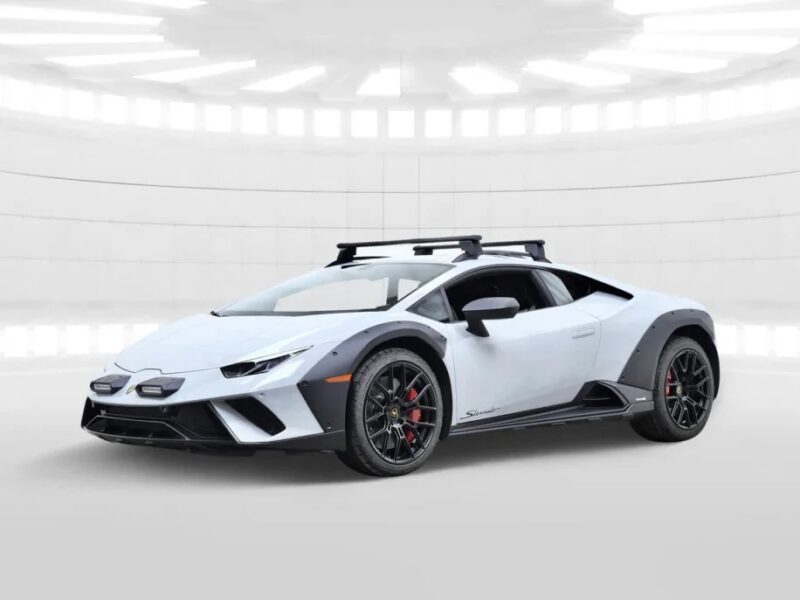 A Lamborghini Huracán Sterrato in pristine white, accented with sleek black details and a practical roof rack, is showcased in a well-lit, futuristic setting.