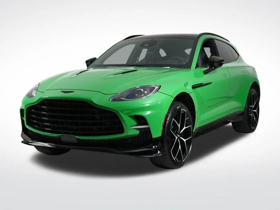 For sale: This Aston Martin DBX 707 is a striking green sports SUV with black accents and a large grille, perfectly embodying the elegance and power of super-SUVs. Photographed beautifully against a white background, it promises unmatched performance and style.