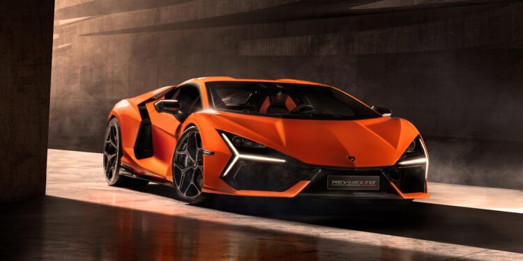 An orange Lamborghini Revuelto with an angular design sits parked in a dimly lit space, its sleek specs barely visible.