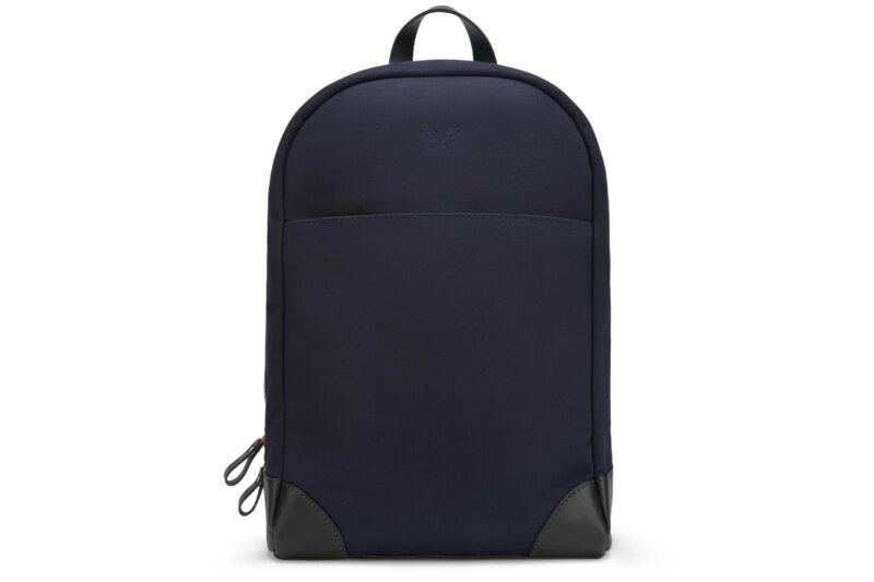 Upgrade your style with this navy blue backpack, featuring black leather corners and a top handle. A perfect blend of practicality and elegance against a crisp white background. Luxury accessories like this are hard to find!.