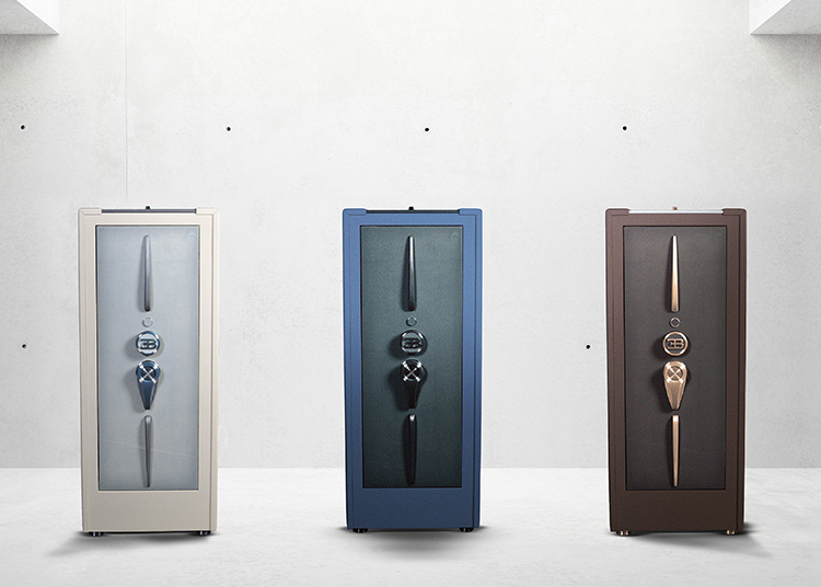 Displayed against a minimalist concrete wall are three modern storage cabinets in white, blue, and brown. Perfect for the style-savvy homeowner, these pieces could easily feature in any 2024 Holiday Gift Guide, offering both functionality and aesthetic appeal.