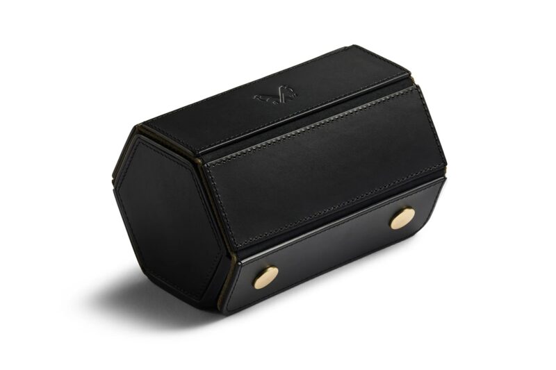 Upgrade your style with this luxurious black leather hexagonal bag, featuring gold accents and a subtle logo on top. Perfect for those seeking luxury accessories, this chic piece is now available for sale.