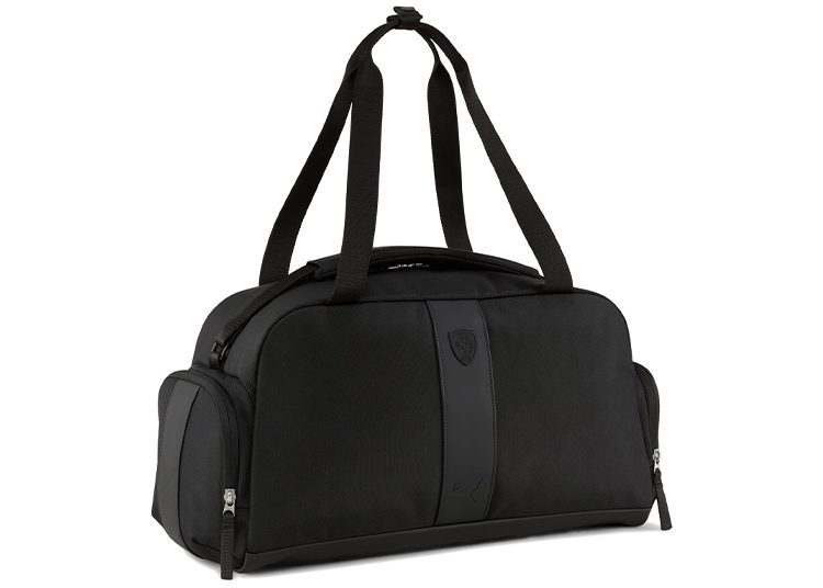 Stylish black duffel bag with two large handles, perfect for a road trip. It features convenient side pockets and a front zipper, making it an ideal travel bag.