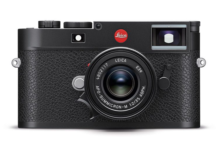 Front view of a black Leica rangefinder camera with a lens attached, featuring a prominent red Leica logo on the body. As highlighted in the duPont REGISTRY's 2024 Holiday Gift Guide, this exquisite piece is perfect for photography enthusiasts.