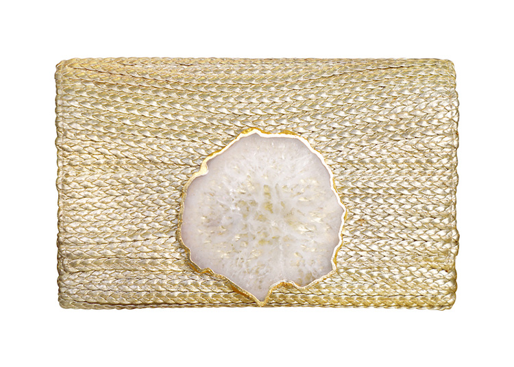 A gold woven clutch with a white, textured geode accent on the front; the perfect addition to any 2024 Holiday Gift Guide.