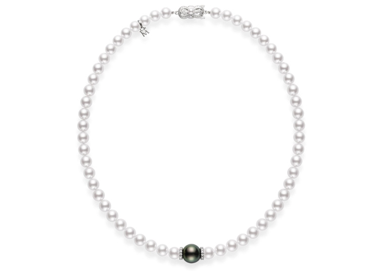 A pearl necklace featuring a clasp and a central dark pearl amidst white pearls makes a stunning addition to the 2024 Holiday Gift Guide by duPont REGISTRY.