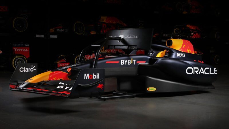 Side view of a Formula 1 car with prominent logos including Oracle, Mobil, and Red Bull on a dark background, as featured in the exclusive duPont REGISTRY 2024 Holiday Gift Guide.