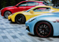 Three Maserati sports cars in a row: the blue one leads in the foreground, followed by the yellow, and finally, the red trailing behind. This lineup is a testament to 110 years of Italian luxury and performance engineering.