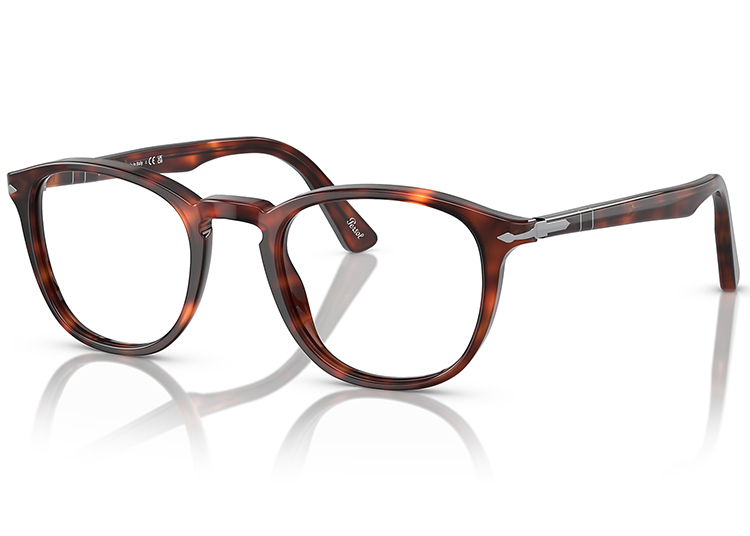 Tortoiseshell eyeglasses with round lenses and silver accents on the temples, featured in the 2024 duPont REGISTRY's Holiday Gift Guide, are displayed on a white reflective surface.