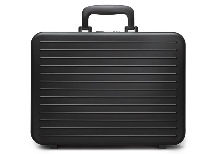 A black hard-shell briefcase with a textured grooved surface is centered against a white background, perfect for your 2024 Holiday Gift Guide shopping needs. Discover this exclusive find on duPont REGISTRY.