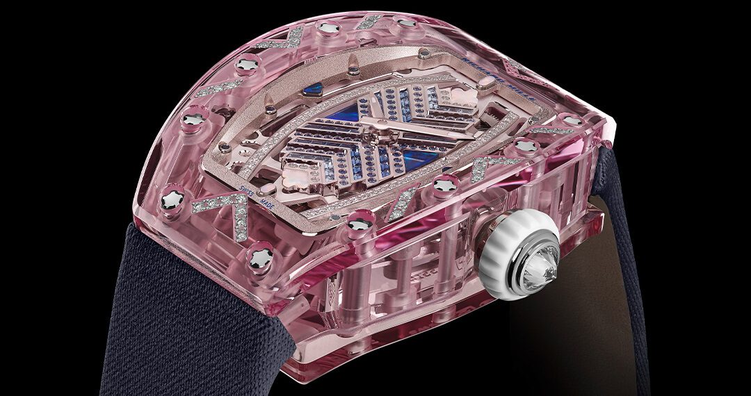 This Richard Mille RM 07-02 wristwatch from the Sapphire Collection boasts a pink skeleton design with a clear case and visible gears, complemented by a black strap and silver crown, set against a sleek black background.