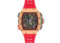 This luxury watch, reminiscent of the Richard Mille RM 65-01, boasts a red strap and a complex dial with multiple subdials, colorful accents, and intricate mechanical details.