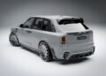 A modified luxury Rolls-Royce Cullinan SUV with a sleek, futuristic design features an enhanced rear bumper and custom wheels, showcased in a studio setting that highlights its Mansory-inspired customization.