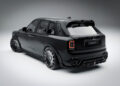 A matte black luxury SUV with distinctive rims and stylized body detailing, the Rolls-Royce Cullinan showcases exquisite Mansory customization, viewed from the rear three-quarter angle.