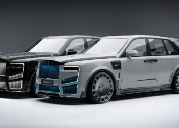 Two luxury cars side by side in a showroom setting, showcasing sleek body designs, tinted windows, and distinctive front grills. One is a stunning Rolls-Royce Cullinan with Mansory customization, enhancing its already magnificent presence.