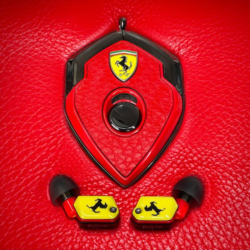 Upgrade your style with these Ferrari-themed wireless earbuds and a matching case, featuring a red and yellow design on a textured red background. Perfect for those seeking luxury accessories, these earbuds are now for sale and ready to elevate your audio experience.