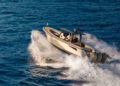 A Wajer Yachts motorboat speeds across blue ocean waves, embodying luxury and leaving a white wake behind it.