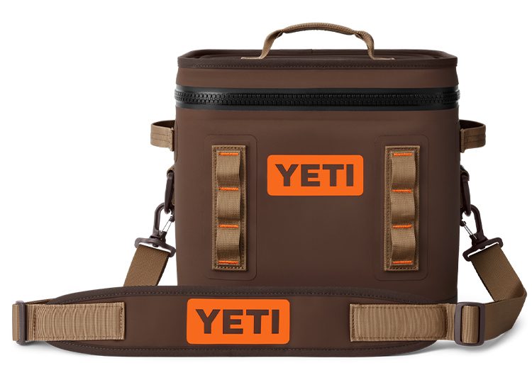 Introducing the 2024 brown Yeti cooler bag featured in the duPont REGISTRY Holiday Gift Guide. This stylish companion boasts a zipper closure, two sturdy handles, and an adjustable shoulder strap for ultimate convenience. Perfect for all your festive adventures!