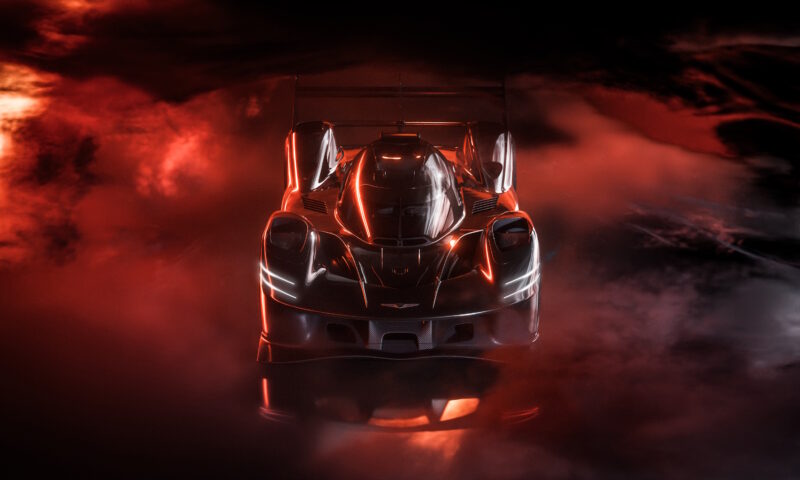 A sleek, futuristic black race car, reminiscent of a Genesis model, with illuminated outlines is surrounded by swirling red and black fog, capturing the high-octane thrill of sportscar racing and creating a dramatic scene.