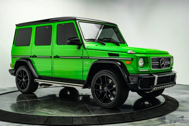 A bright green luxury SUV with a powerful V12 engine and black accents proudly displays its visible logo. It's parked in a studio with a light-colored background, seen from the side angle, exemplifying the allure of exotic cars.