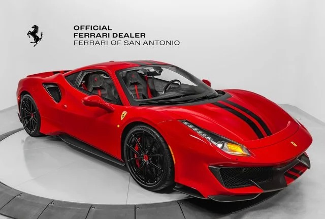 A red Ferrari sports car with black stripes is displayed in a showroom, epitomizing the allure of an exotic car. The text reads, "Official Ferrari Dealer, Ferrari of San Antonio, where your luxury car dreams come true.