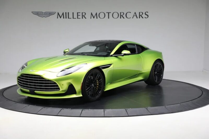 A lime green sports car, epitomizing the world of exotic cars, is displayed on a rotating platform at Miller Motorcars showroom.