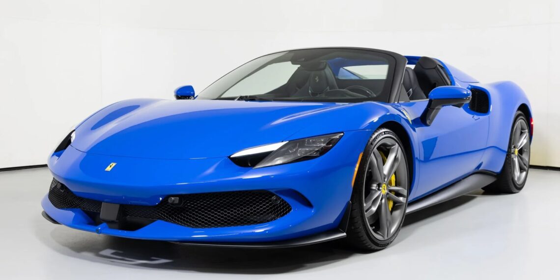 This exotic blue sports car, with its sleek design, low profile, and sporty wheels, is parked in a bright, minimalistic indoor space. Perfect for luxury car enthusiasts searching through for sale listings.