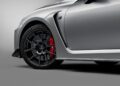 Close-up of a silver Lexus 2025 RC F's front wheel, featuring black alloy rims and red brake calipers, showcasing the sleek design of this Final Edition.