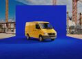 A yellow Mercedes-Benz Sprinter van is parked on a vivid blue platform at a construction site, with cranes and building materials in the background, celebrating its 30th Anniversary.