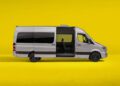 A white Mercedes-Benz Sprinter van with a sliding side door open is set against a bright yellow background, celebrating its 30th Anniversary with modern style and versatility.