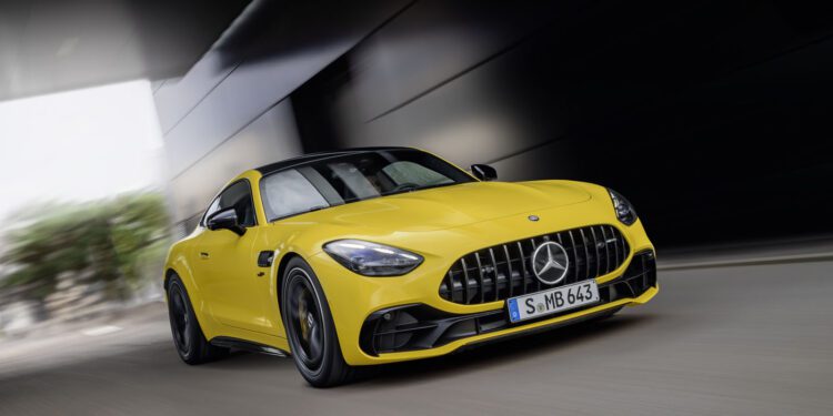 A stunning yellow Mercedes-Benz sports car, emblematic of the PHEV sales growth anticipated in Q4 2024, races through a tunnel, captured from an impressive front angle.