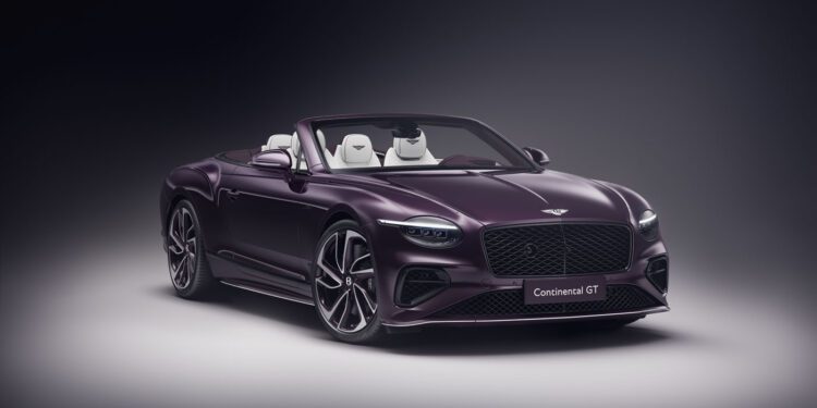 A sleek, purple Bespoke Bentley convertible sports car with the top down showcases a luxurious interior against a dark background, reminiscent of the elegance found in a $1.7M auction masterpiece.