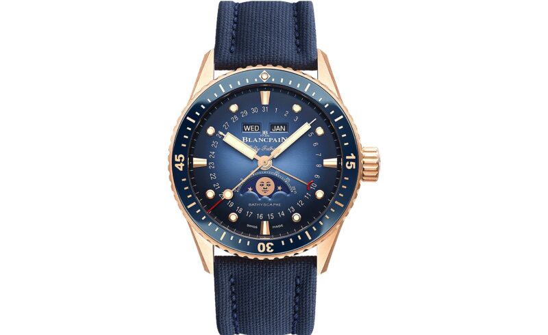 Discover one of the best luxury watches, a masterpiece with a blue face that elegantly displays day, date, and month. It features a moon phase indicator set in a gold-toned case and is complemented by a stylish blue fabric strap.