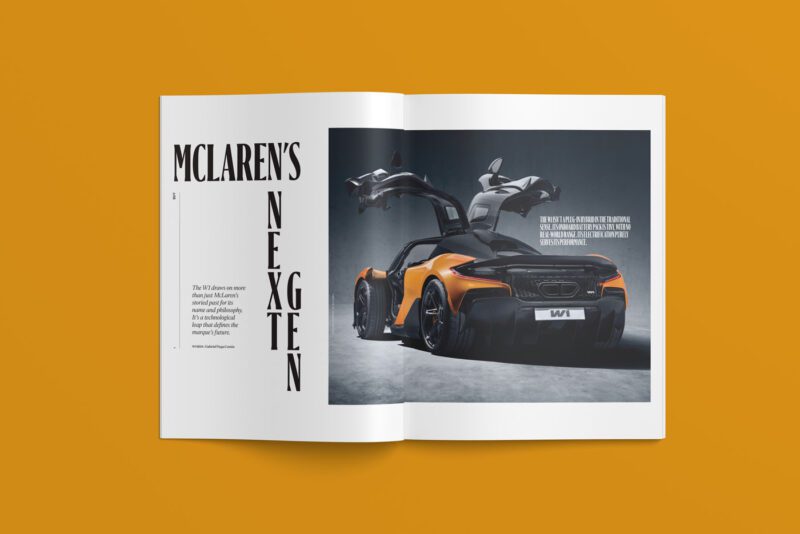 Open magazine on a table, showcasing a McLaren car with gullwing doors on the right page and the title "McLaren's Next Gen" on the left page. This exclusive feature is part of duPont REGISTRY No. 477, set to hit the stands in February 2025.