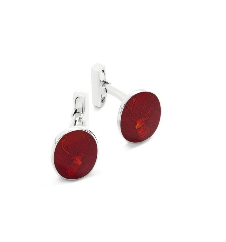 Introducing luxury accessories for the discerning gentleman: two silver cufflinks with round red faces, elegantly engraved with a deer head design. Perfect to upgrade your style and make a statement.